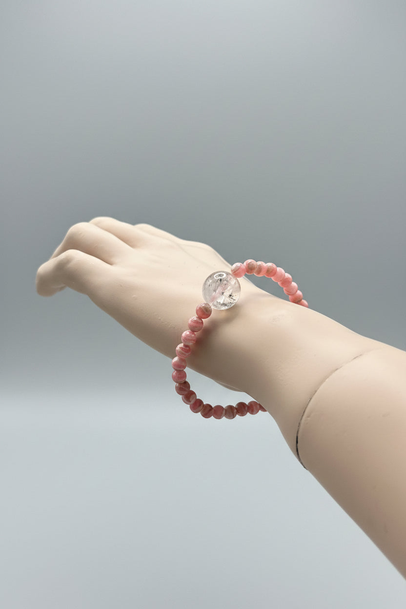 A bracelet for the woman who has survived, healed, and chosen herself.

Featuring luminous Herkimer Diamond and vibrant Rhodochrosite, this handcrafted TMB bracelet embodies courage, self-love, emotional healing, and the strength to keep your heart open after life’s greatest lessons.

Rhodochrosite is known as the Stone of the Compassionate Heart, encouraging deep emotional healing, self-worth, and the release of old wounds. Paired with the high-vibrational clarity of Herkimer Diamond!